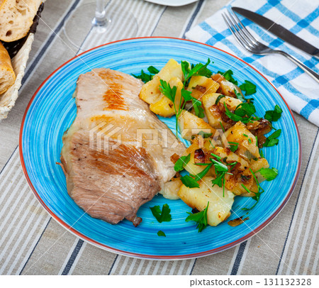Steaks of pork loin with homestyle boiled potatoes Steaks of pork loin with homestyle boiled potatoes 131132328