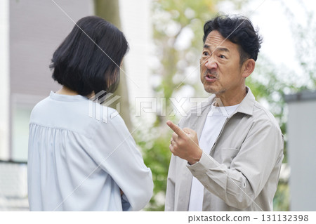 Middle-aged couple fighting outdoors 131132398