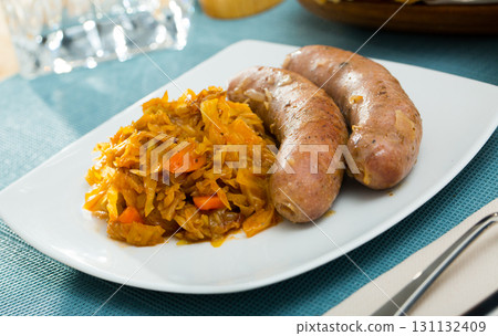 Dish of meat sausages with braised cabbage served 131132409
