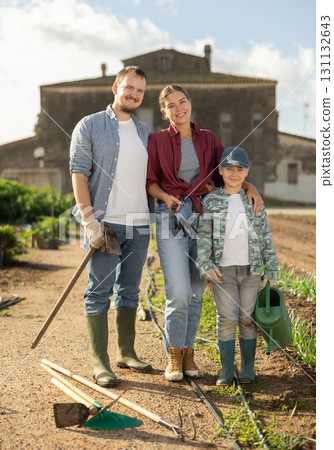 Man woman and boy near field harvest 131132643