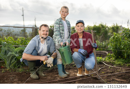 Family of farmers standing in the garden Family of farmers standing in the garden 131132649