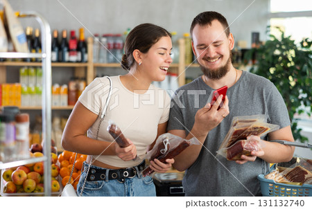 couple scans the QR code of meat products on their phone 131132740