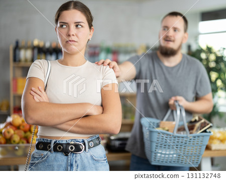 Man and woman quarrel in supermarket - they shout at each other Man and woman quarrel in supermarket - they shout at each other 131132748