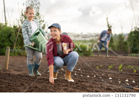 Woman and her son plant seeds Woman and her son plant seeds 131132790