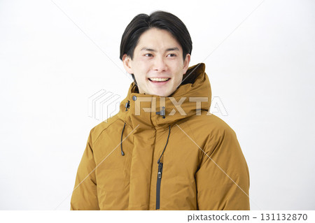 Man wearing down jacket, portrait, white background 131132870