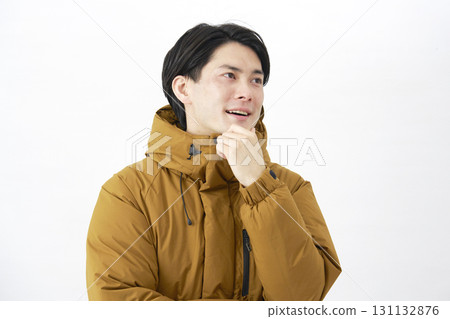 A man wearing a down jacket imagines white background A man wearing a down jacket imagines white background 131132876