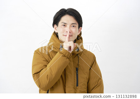 Man wearing down jacket, secret gesture, white background Man wearing down jacket, secret gesture, white background 131132898