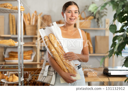 Young woman with baguette in bakery 131132912