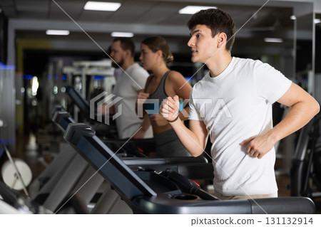 Guy running on the treadmill 131132914