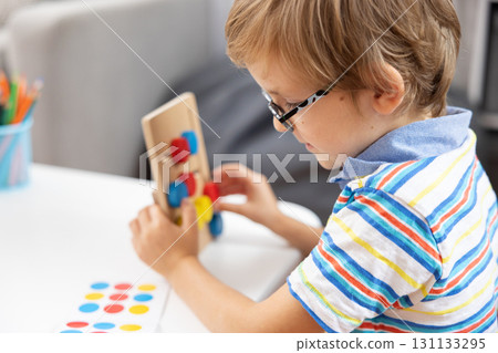 Child Engaged in Educational Toy Activity at Home Child Engaged in Educational Toy Activity at Home 131133295