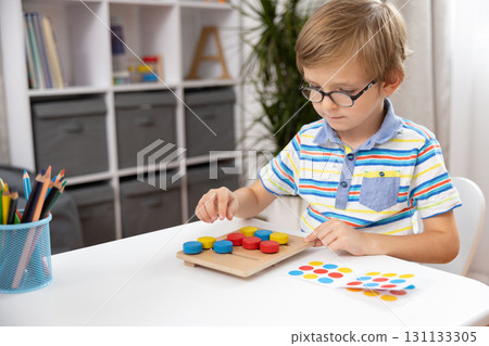 Child Engaged in Educational Puzzle Activity at Home 131133305