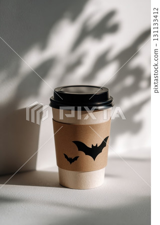 Halloween Coffee Cup Mockup with Bat Shadows on White Surface 131133412