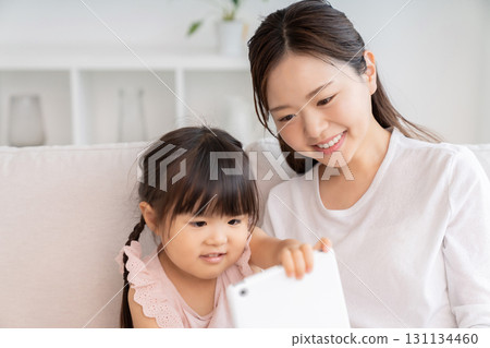 Mother and 3-year-old girl tablet Mother and 3-year-old girl tablet 131134460