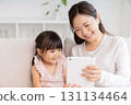 Mother and 3-year-old girl tablet 131134464