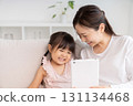Mother and 3-year-old girl tablet 131134468