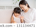 Mother and 3-year-old girl tablet 131134471
