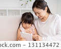 Mother and 3-year-old girl tablet 131134472