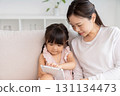 Mother and 3-year-old girl tablet 131134473
