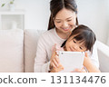 Mother and 3-year-old girl tablet 131134476
