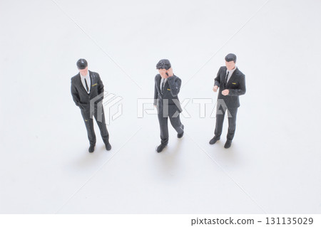 the Three Miniature Businessmen In Suits Stand 131135029