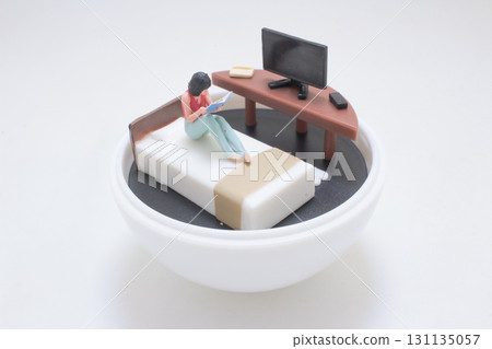 Miniature Person Reading In Bed With Desk 131135057