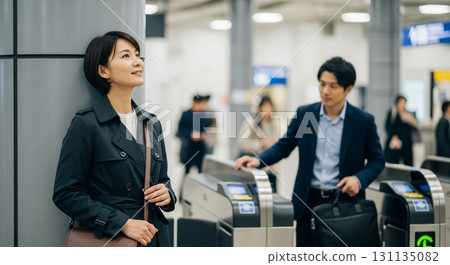 A young woman waiting for him at the ticket gate. Meeting. 131135082