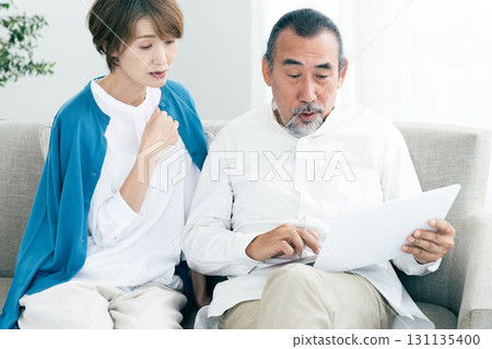Senior couple looking at laptop Senior couple looking at laptop 131135400