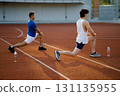 Two asian athlete men are stretching their legs muscles together on the racetrack in sports stadium. 131135955
