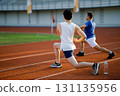 Two asian athlete men are stretching their muscles together on the racetrack in sports stadium. 131135956