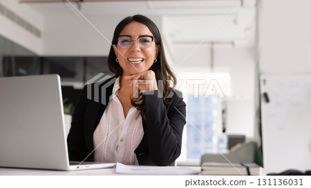 Happy confident mature businesswoman in stylish glasses posing in office Happy confident mature businesswoman in stylish glasses posing in office 131136031