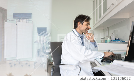 Happy mature male doctor using pc at workplace watching webinar Happy mature male doctor using pc at workplace watching webinar 131136032