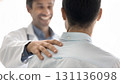 Close up shot happy doctor touch male patient shoulder 131136098