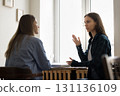 Young woman client visit advisor lawyer speak about problem 131136109