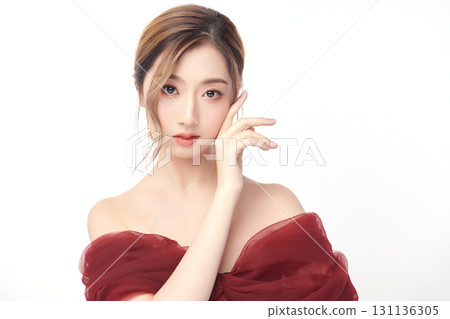 A beautiful young Asian woman with clean, fresh skin against a white background. Skincare, facial treatment, cosmetology, beauty, and spa. An elegant portrait of an Asian woman. A beautiful young Asian woman with clean, fresh skin against a white background. Skincare, facial treatment, cosmetology, beauty, and spa. An elegant portrait of an Asian woman. 131136305