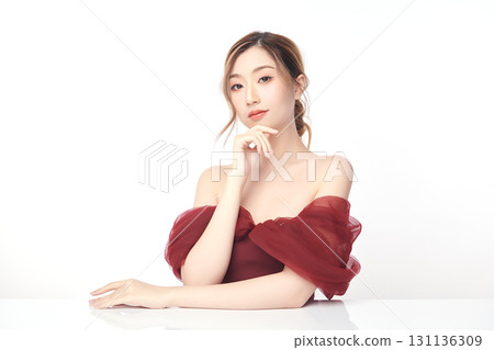 A beautiful young Asian woman with clean, fresh skin against a white background. Skincare, facial treatment, cosmetology, beauty, and spa. An elegant portrait of an Asian woman. 131136309