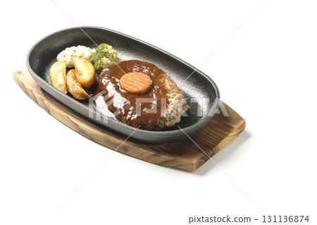 Hamburger steak plate with side dishes of fries, potato salad, and broccoli photographed against a white background Hamburger steak plate with side dishes of fries, potato salad, and broccoli photographed against a white background 131136874
