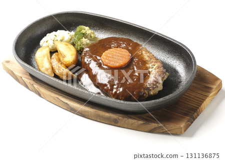 Hamburger steak plate with side dishes of fries, potato salad, and broccoli photographed against a white background Hamburger steak plate with side dishes of fries, potato salad, and broccoli photographed against a white background 131136875