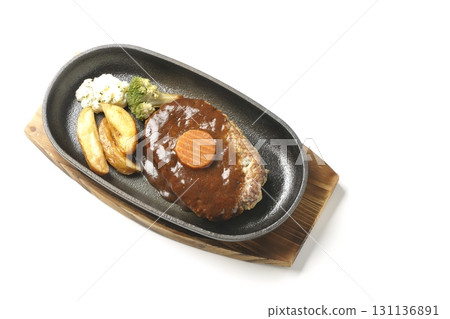 Hamburger steak plate with side dishes of fries, potato salad, and broccoli photographed against a white background Hamburger steak plate with side dishes of fries, potato salad, and broccoli photographed against a white background 131136891