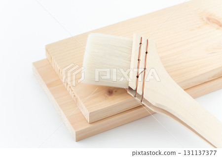 Wooden board and brush on white background 131137377