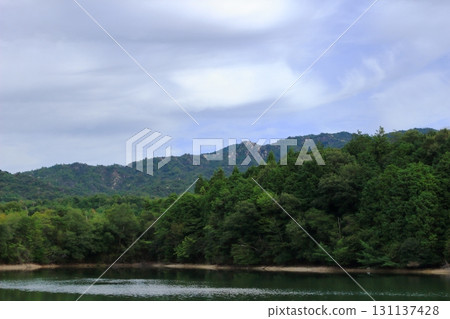The rocky terrain of the Konsho Alps seen across the pond The rocky terrain of the Konsho Alps seen across the pond 131137428