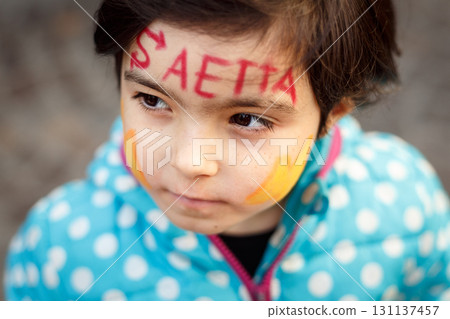 portrait of a child with face painting at carnival with writing in Italian Lightning 131137457