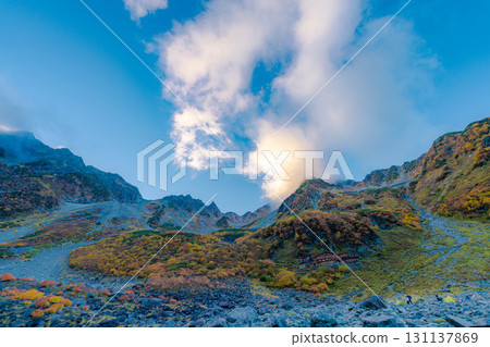 [Autumn leaves] Scenery of Karasawa Cirque with clouds forming as autumn leaves reach their peak [Nagano Prefecture] 131137869