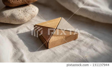 Wooden geometric puzzle arranged as square on fabric surface 131137944