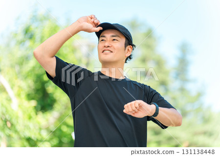 A middle-aged man in sportswear using a smartwatch to manage his health and health care 131138448