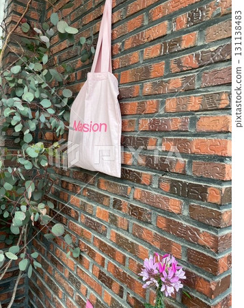 Bag hanging on a brick wall 131138483