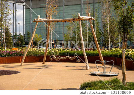 rope bridge in playground in park, while a round merry-go-round lies nearby. Park near Keruen Shopping Center. Astana (Nur-Sultan), Kazakhstan - 08.20.25 rope bridge in playground in park, while a round merry-go-round lies nearby. Park near Keruen Shopping Center. Astana (Nur-Sultan), Kazakhstan - 08.20.25 131138609