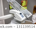Surgery instruments are neatly organized in a contemporary dental clinic setting, highlighting cleanliness and precision. 131139514