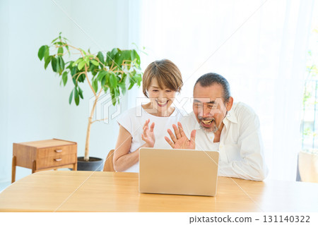A middle-aged couple making a video call 131140322
