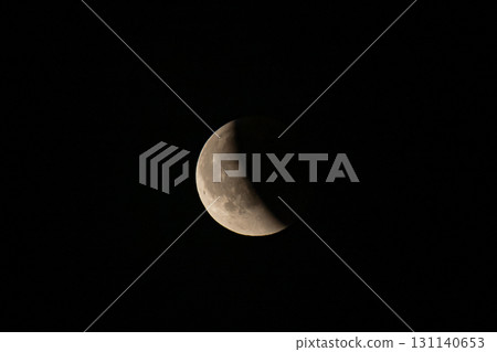 Lunar eclipse beginning close-up right corner sun begins to come on top of moon lunar eclipse black background at night Lunar eclipse beginning close-up right corner sun begins to come on top of moon lunar eclipse black background at night 131140653