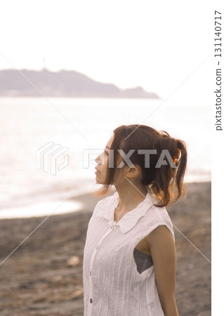 Shonan Coast - A woman on the beach at dusk 131140717